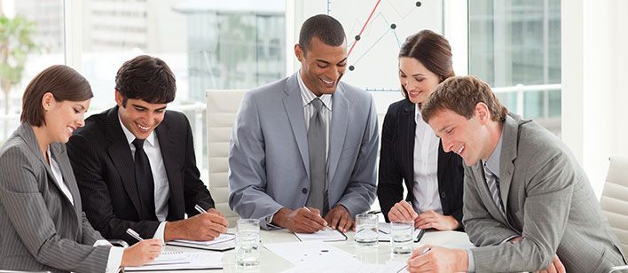 happy, smiling corporate meeting attendees applauding